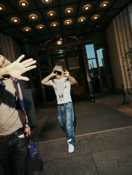 ski aggu covering his face outside luxury hotel, paparazzi style